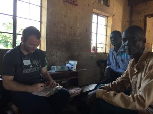 Dr. Luke Husby evaluating a patient in a mobile clinic in rural Uganda.